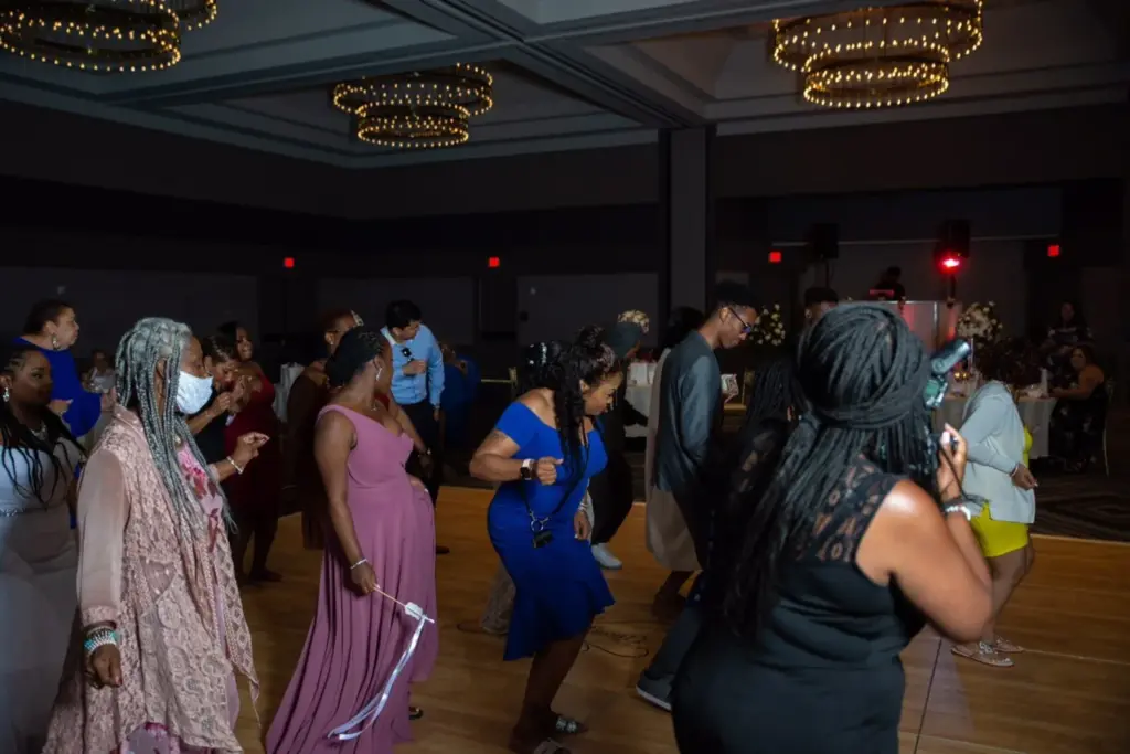 Ballroom wedding reception glowing with red uplighting