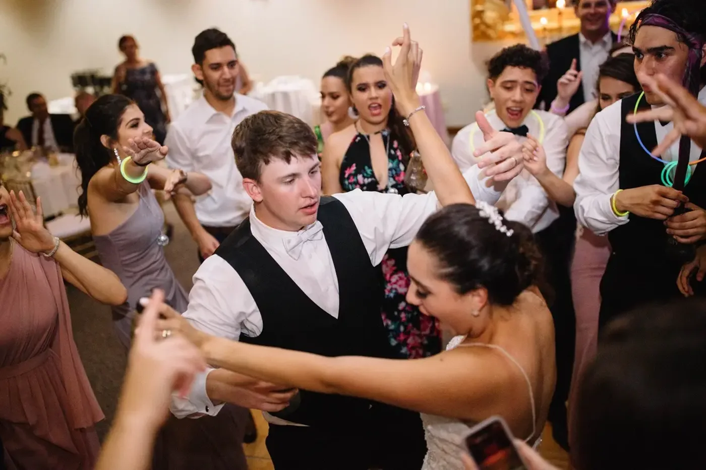 Newlyweds celebrating with their crowd on the dance floor