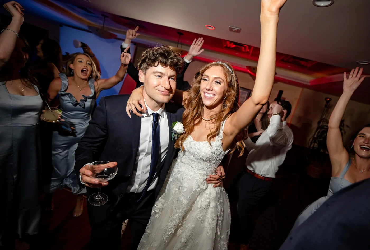 A packed dance floor glowing at a lively celebration