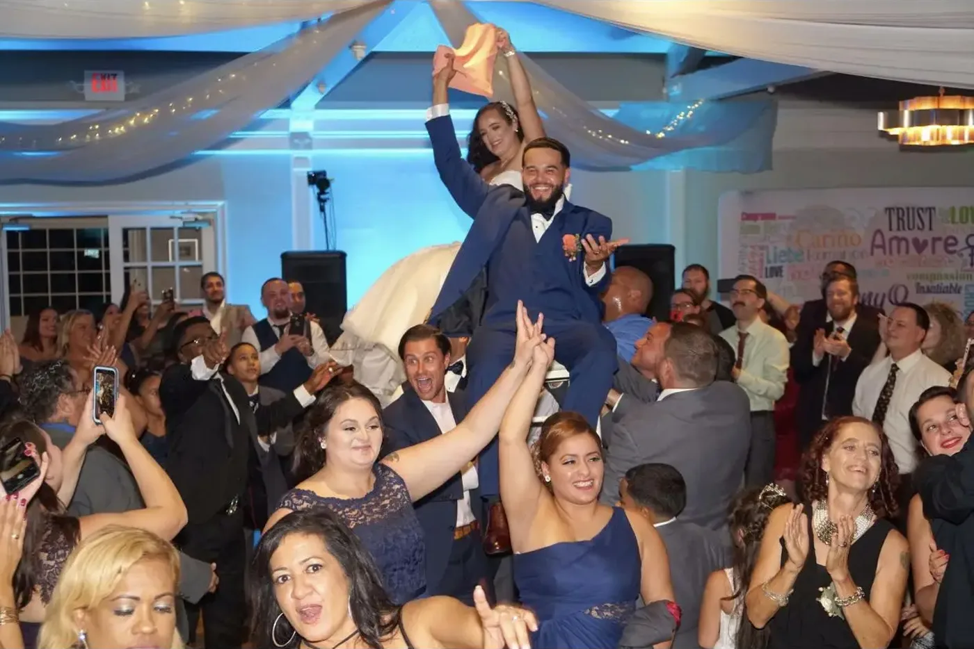 A packed dance floor glowing at a lively celebration