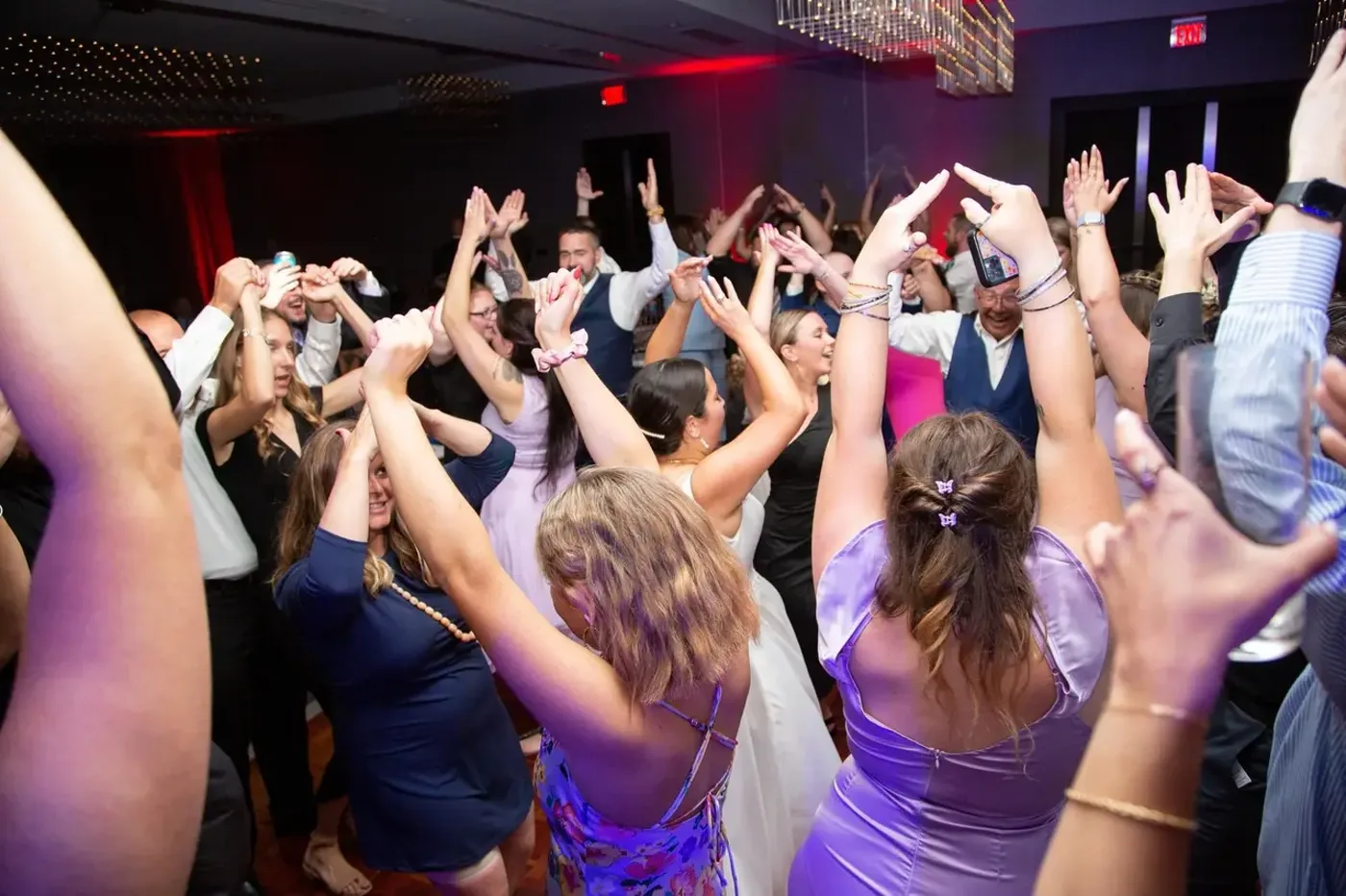 Newlyweds celebrating with their crowd on the dance floor