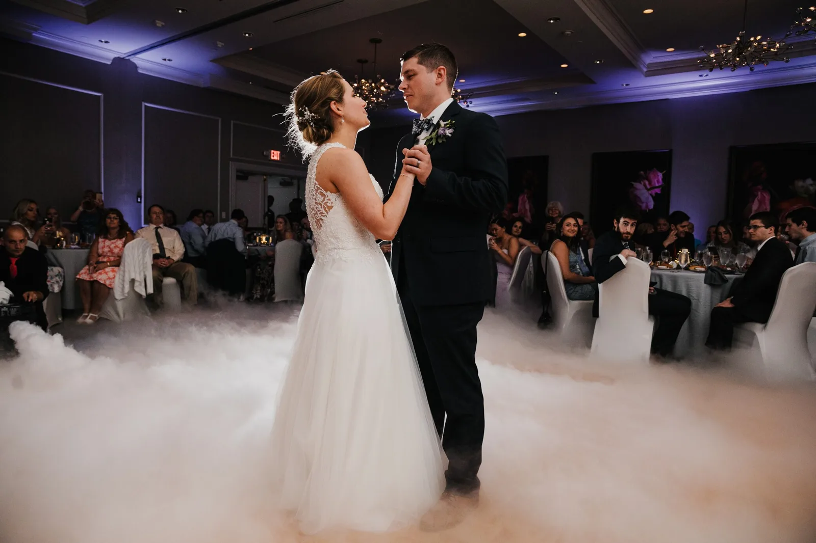 Newlyweds sharing their first dance surrounded by low-lying cloud fog at a Detroit reception