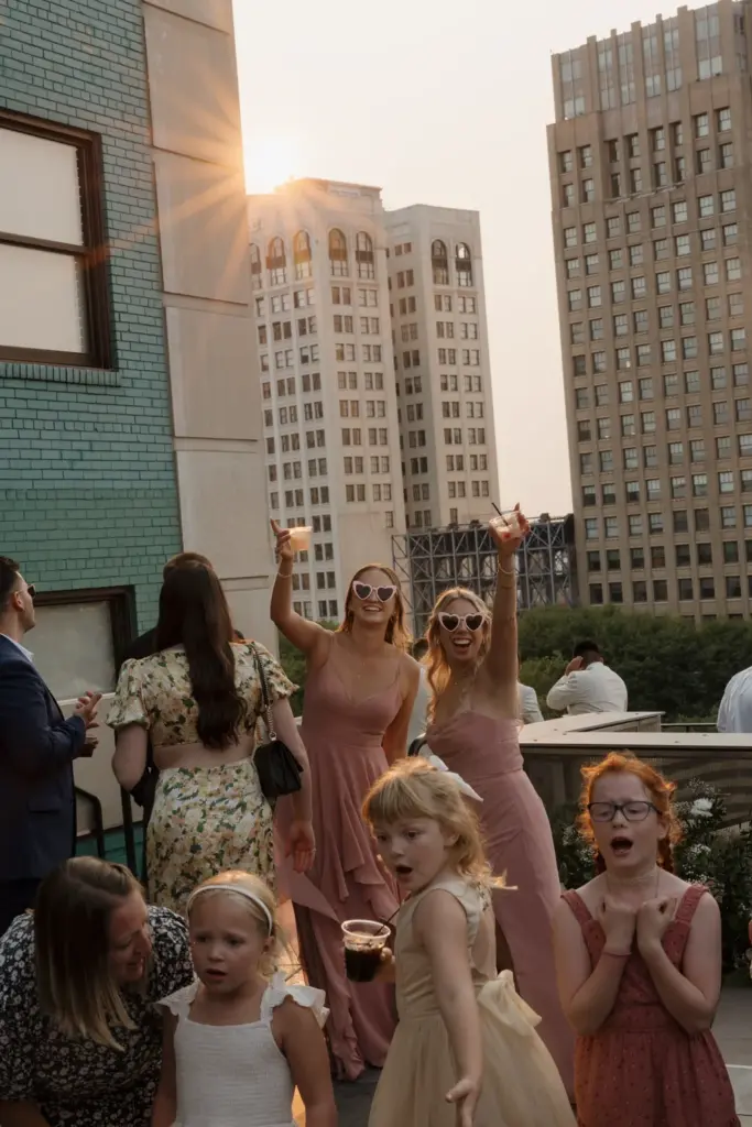 Bride and groom kissing on a Detroit rooftop at dusk