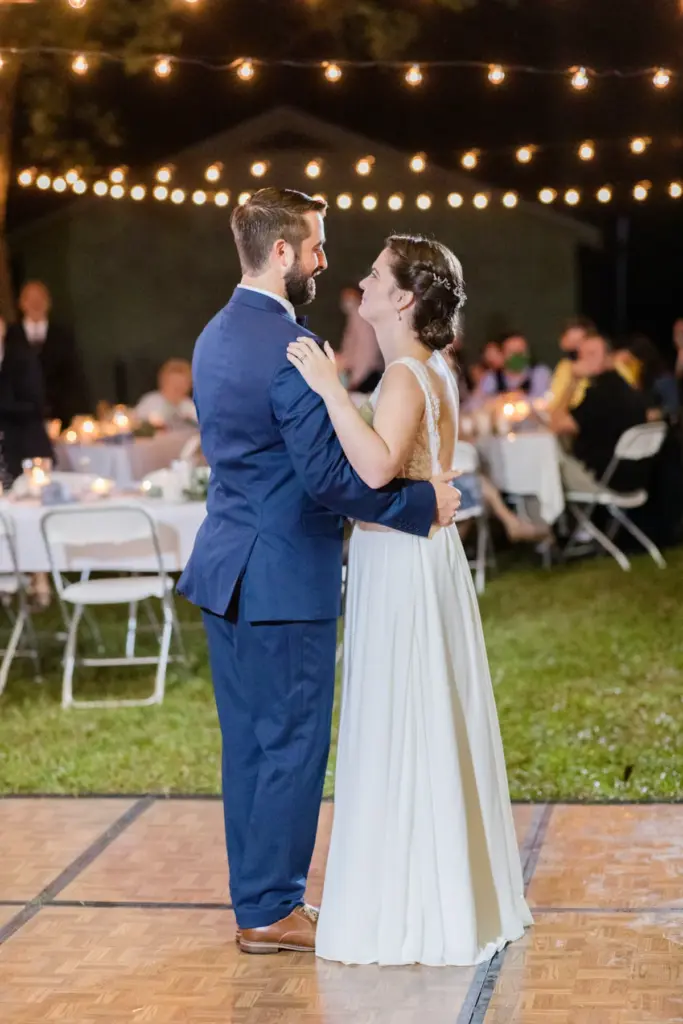 First dance under string lights at a Michigan wedding reception