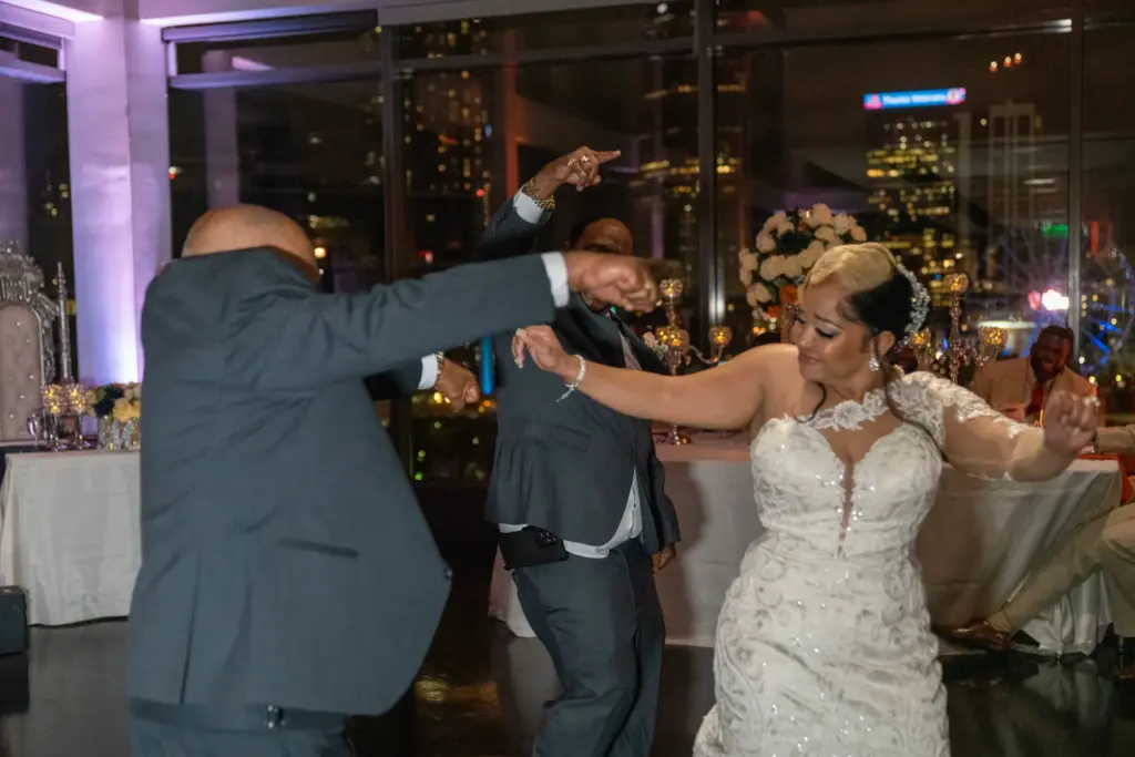 Wedding DJ purple and orange uplighting as a couple dances