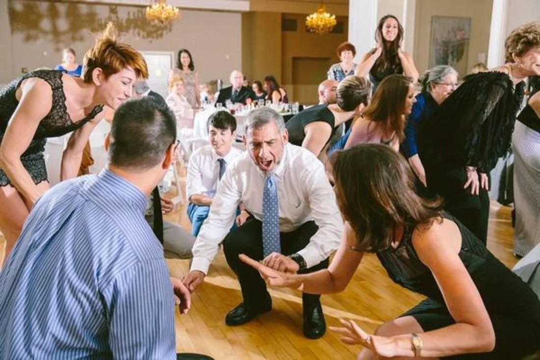 A guest dancing with big energy at a wedding celebration