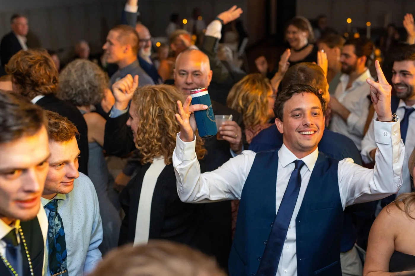 Guests packing the dance floor at a wedding reception