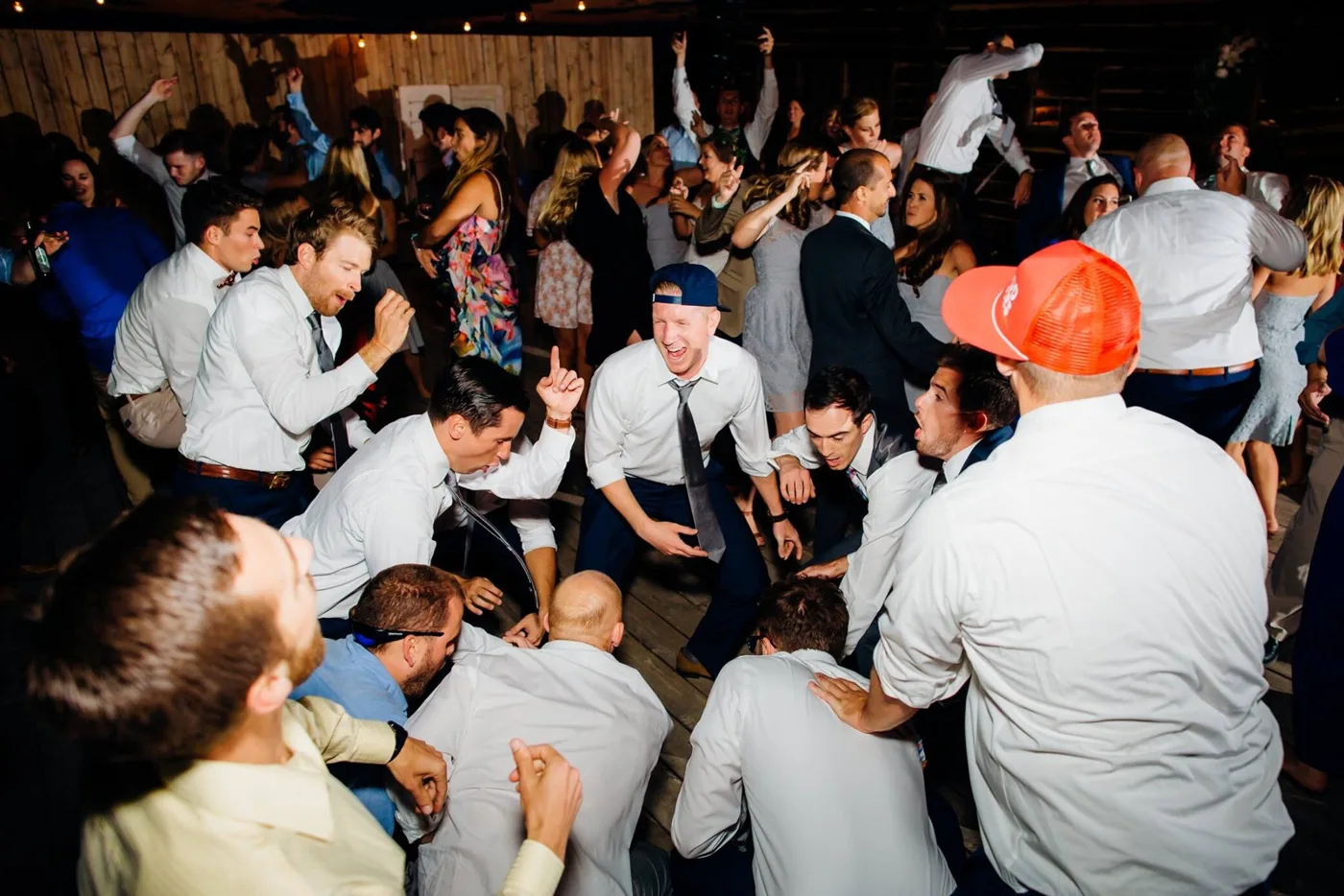 A packed dance floor glowing at a lively celebration
