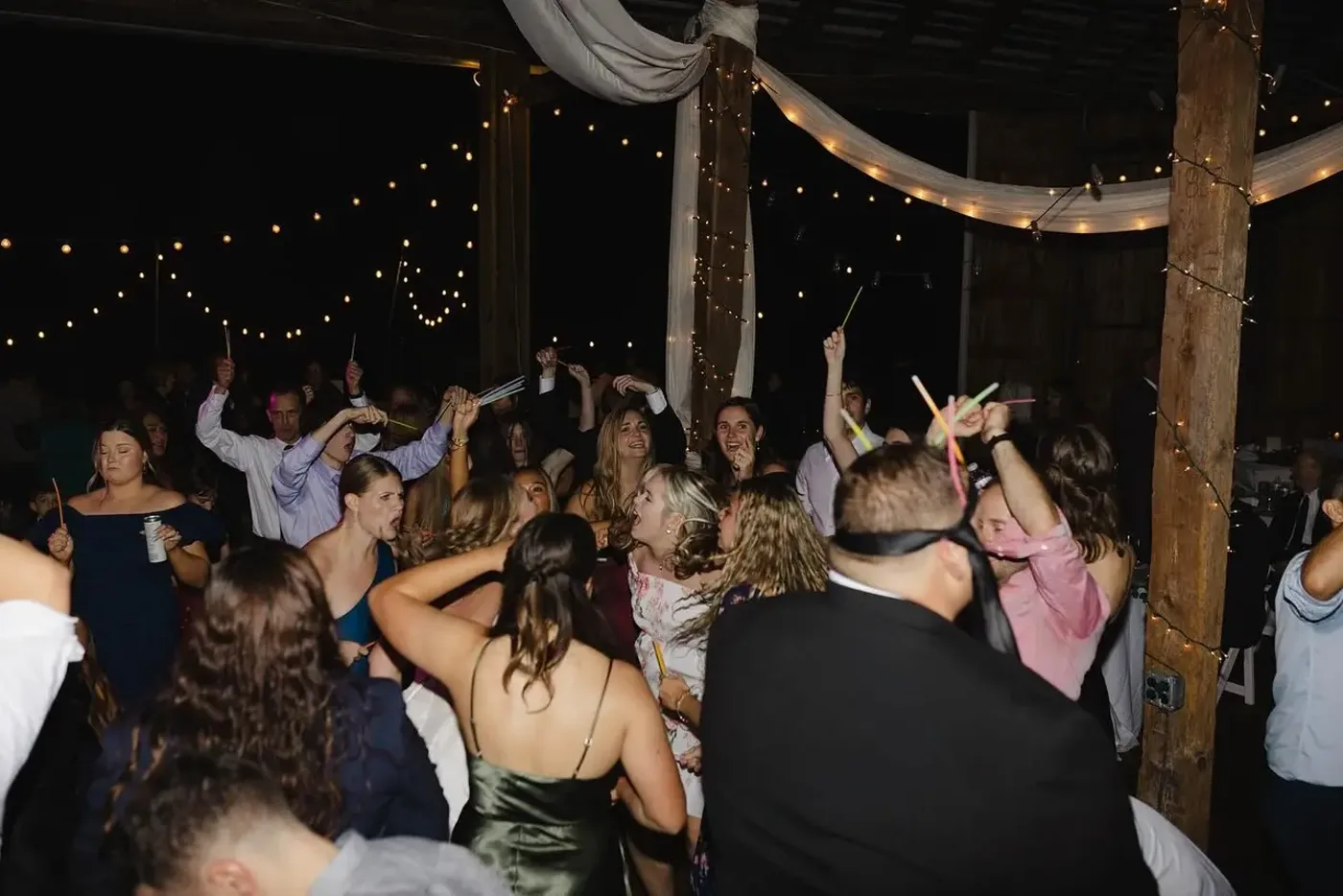 Guests dancing under warm string lights