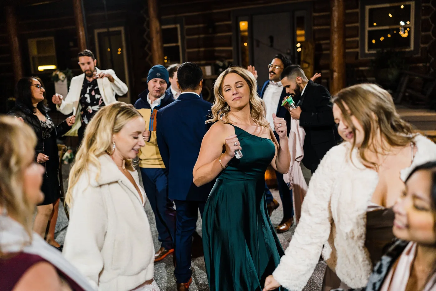 Newlyweds surrounded by friends on the dance floor