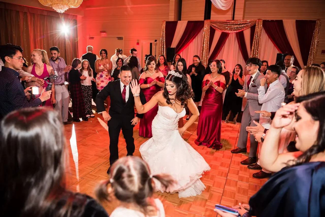 Bride dancing under warm uplighting